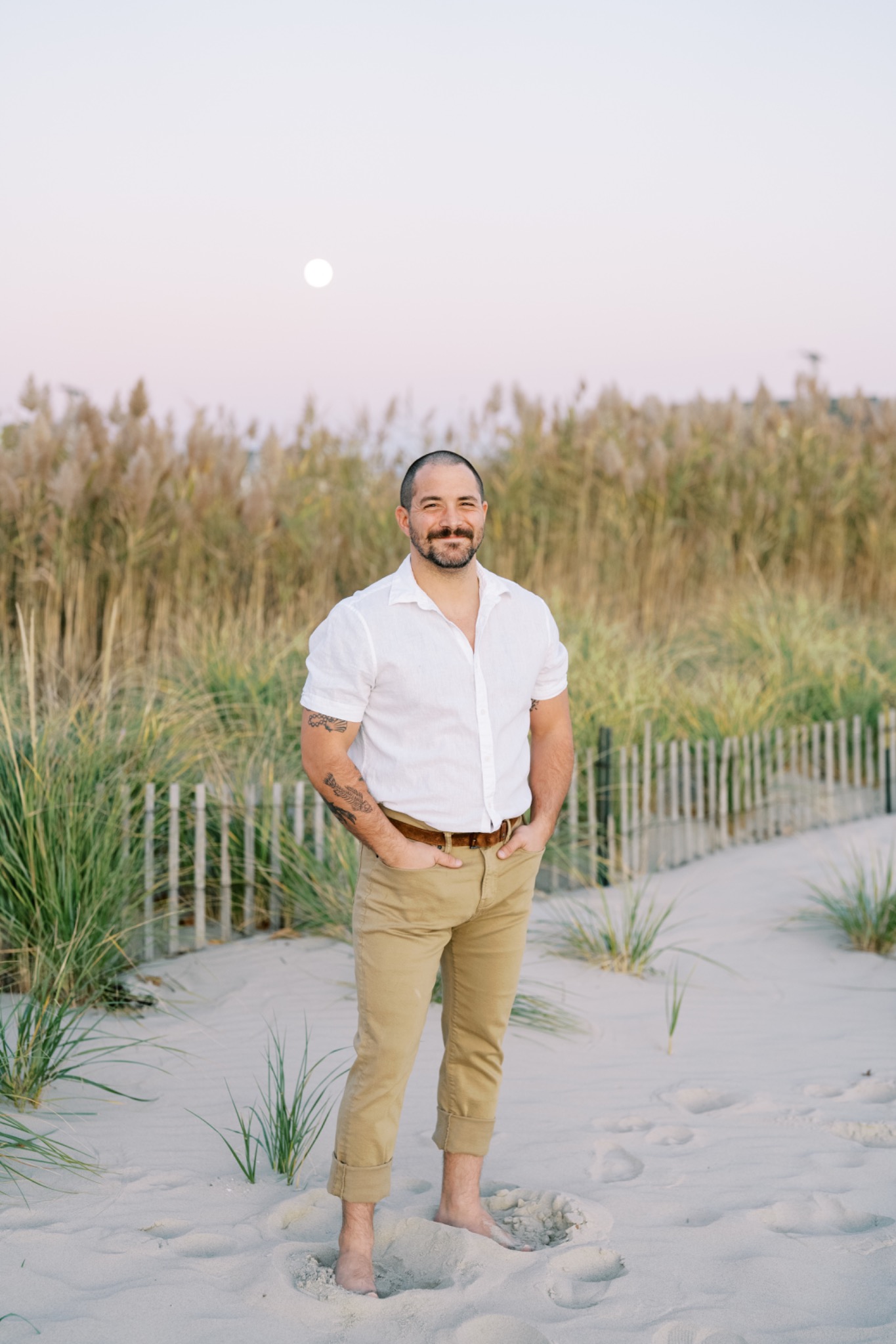 Thomas Post standing among coastal dunes